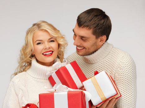 picture of family couple in a sweaters with gift boxes