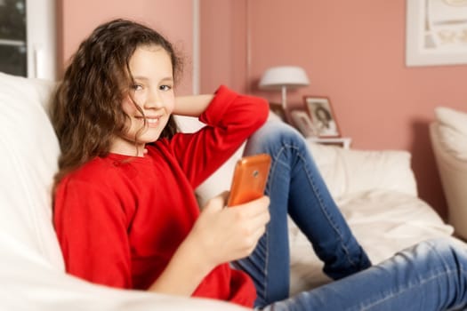 An image of a young girl with a mobile phone