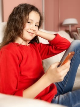 An image of a young girl with a mobile phone