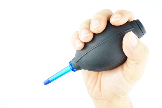 Hand hold black blower for cleaning the camera and sensor isolated with white background.