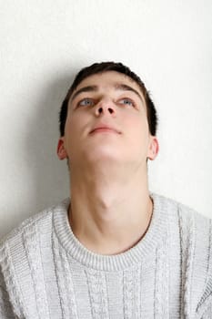 Teenager thinking near the wall at the Home