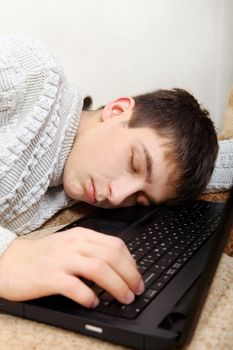 Tired Teenager sleeping on the Laptop closeup