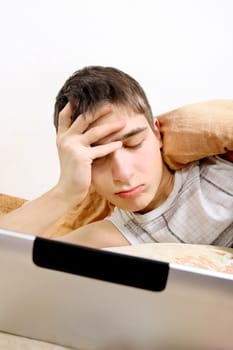 Tired Teenager with Tablet Computer at the Home