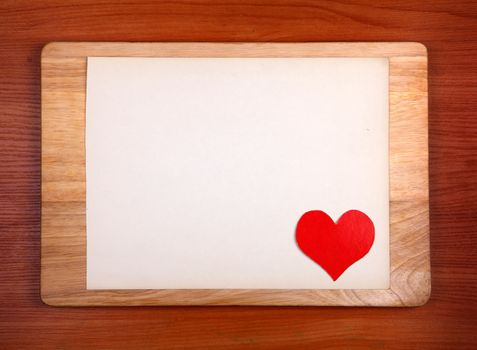 Notice Board with Heart Shape on Wooden Background