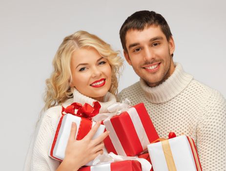 picture of family couple in a sweaters with gift boxes