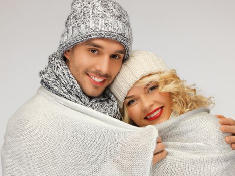 bright picture of family couple under warm blanket