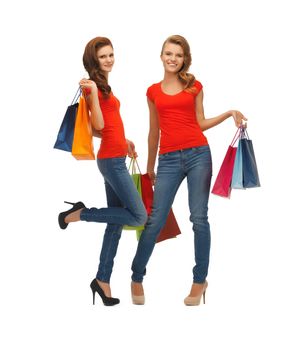 two teenage girls in red t-shirts with shopping bags