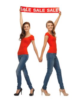 two teenage girls in red t-shirts with sale sign