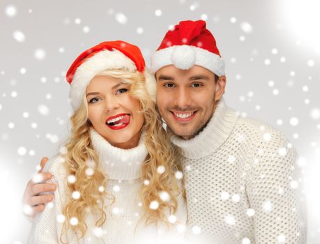 picture of family couple in sweaters and santa's hats