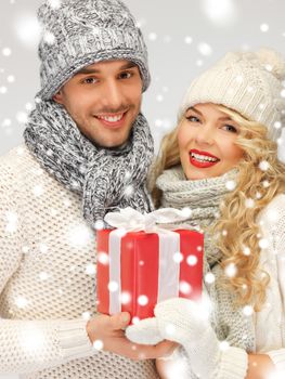 picture of romantic couple in a sweaters with gift box