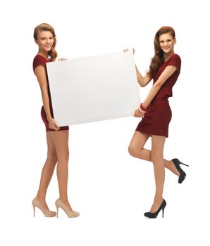 picture of two teenage girls in red dresses with blank board