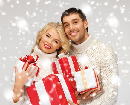 picture of romantic couple in a sweaters with gift boxes