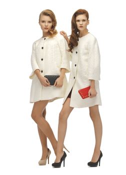 picture of two teenage girls in white coats with clutches