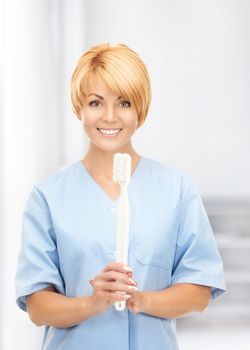 picture of attractive female doctor with toothbrush.