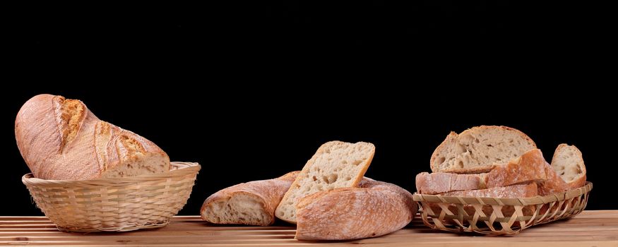 several different types of bread on a black background