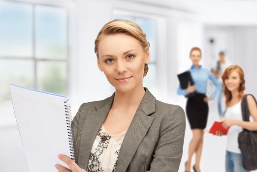 picture of teacher with notebook and students