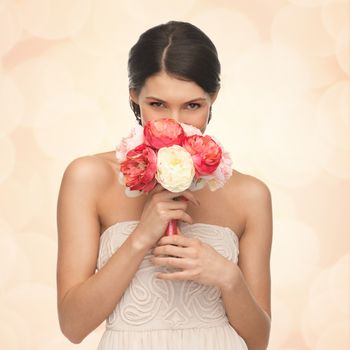 picture of young woman smelling bouquet of flowers