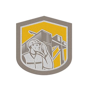 Metallic styled illustration of a dock worker on phone calling with shipping containers in the background set inside shield crest done in retro style.