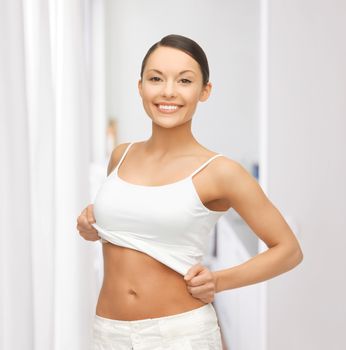 happy woman taking off blank white t-shirt