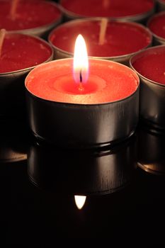 red candle on a black background