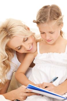 picture of mother and daughter doing home work