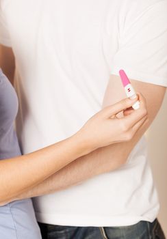 close up of woman and man hands with pregnancy test