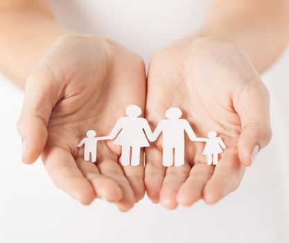 close up of womans cupped hands showing paper man family