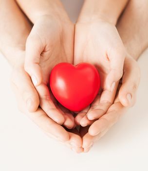 close up of woman and man hands with heart