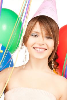 happy girl with colorful balloons in party cap