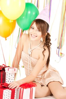 picture of happy girl with colorful balloons and gift boxes