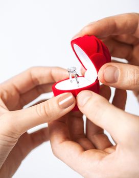 couple hands with wedding ring and gift box.