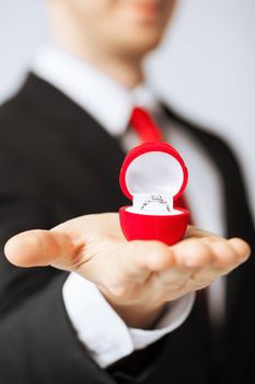 man making proposal with wedding ring and gift box.