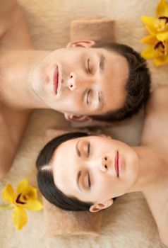 picture of couple in spa salon lying on the massage desks