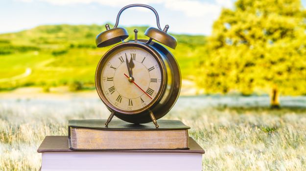 Clock on Bible front of monitor.