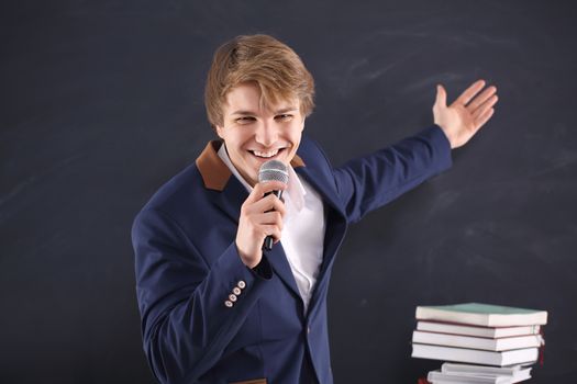Young man with a microphone during the presentation of energy