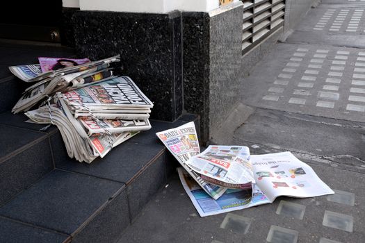 LONDON, UK - MAY 25, 2014: Tabloid newspapers in a shop doorway on May 25, 2014. Headlines in the Daily Mirror report on the four sailors lost at sea after their yacht ran into trouble in the Atlantic.