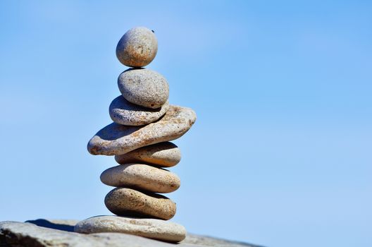 Balancing of white pebbles each other on the seacoast