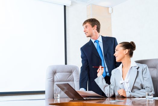 image of a two businessmen discussing documents, teamwork