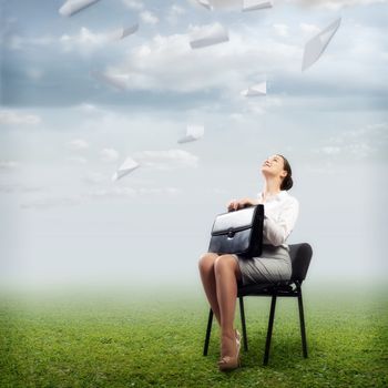 image of a business woman looking at the falling paper