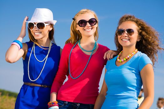 three young attractive girls having fun together, spend fun time with friends