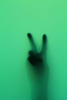 Hand silhouette on green glass