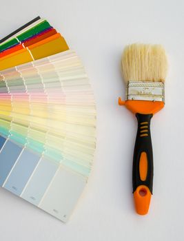 pastel shade color palette chart and working paint brush on white background