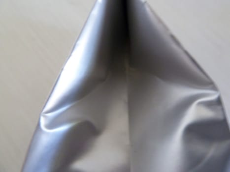 Bright shiny silver package in closeup as a background 