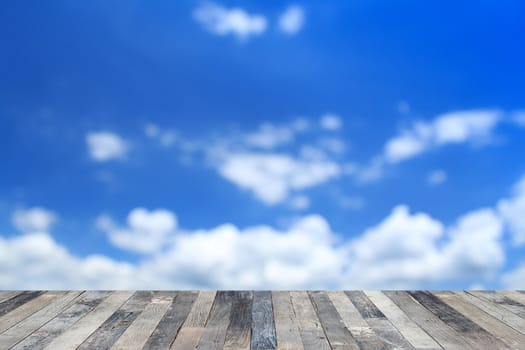 View of the blue sky above a wooden floor