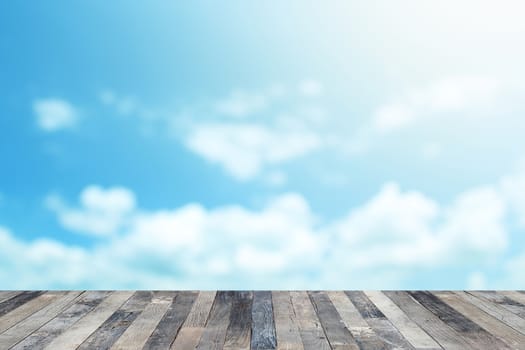 View of the blue sky above a wooden floor