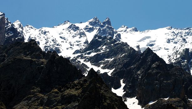 Caucasus mountains under snow and clear blue sky