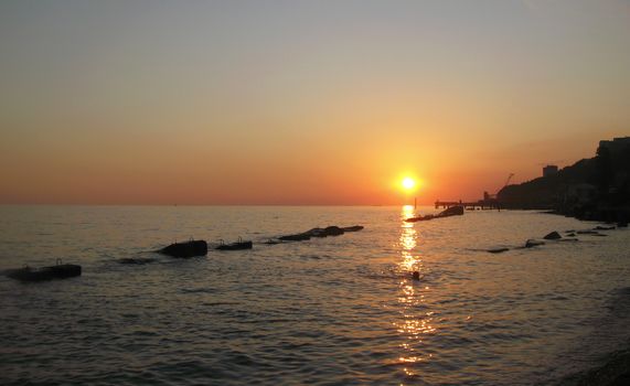 Sunset over summer sea with a small waves