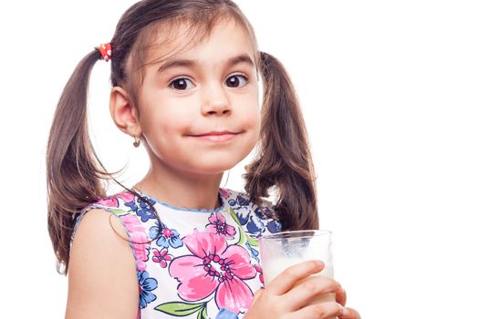 Young girl drinking milk out of glass on white background