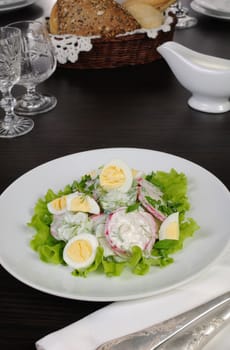 Radish salad with cucumber and quail eggs for milk sauce