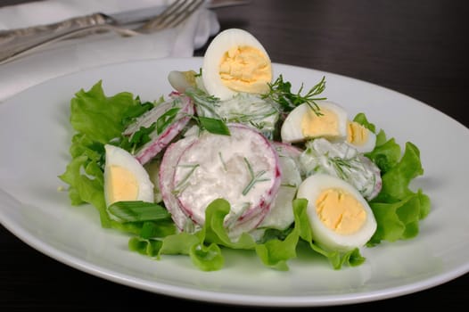 Radish salad with cucumber and quail eggs for milk sauce